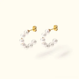 18K gold pearl stud earrings flat lay top view premium freshwater pearls gold posts
