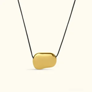 18K gold pebble pendant necklace with black cord, flat lay product photography on neutral background