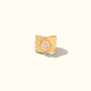 Pink gemstone 18K gold open cuff ring with ridged textured band, front flat lay view on plain light background