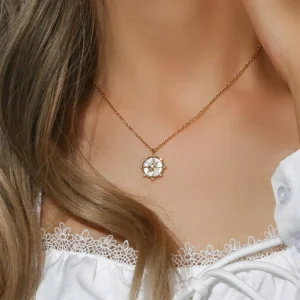 gold compass pendant necklace worn on model showing delicate chain and pendant styling with white lace top close-up