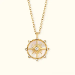 18K gold polaris compass star pendant necklace front flat lay display with diamond simulants on off-white background