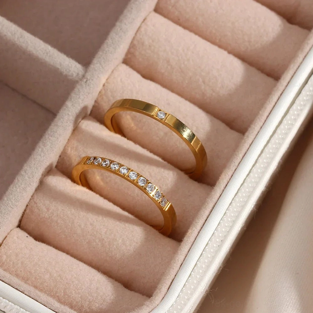 18K gold ring collection both mono and poly styles elegantly displayed in pink jewelry storage case