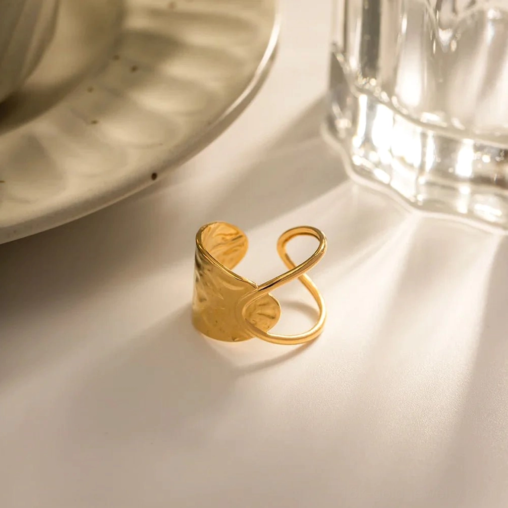 18K gold hammered open ring oblique angle flat lay with ceramic dinnerware styling