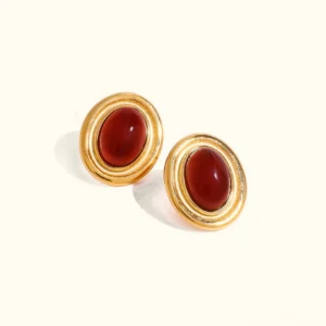 18K gold ruby stud earrings with double bezel cabochon red gemstone in polished gold setting flat lay