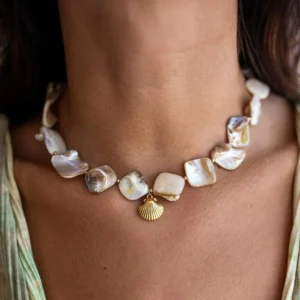 Close-up view of 18K gold seashell necklace worn on female neck showing choker fit and central gold shell charm detail