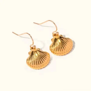 18K gold seashell dangle earrings frontal view on white background, ribbed shell charm with French hooks, professional jewelry photography