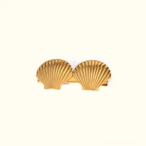 18K gold seashell hair clip front view showing polished ribbed shell texture on plain background