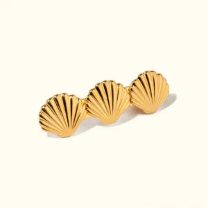 18K gold seashell hair clip triple shell design polished finish flat lay view