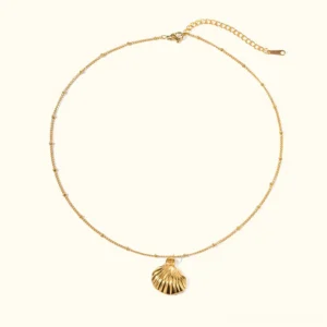 18K gold seashell pendant necklace flat lay view featuring delicate satellite chain with ribbed textured shell charm on plain white background