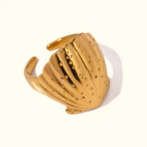 18K gold seashell adjustable open ring with embossed ribbed shell design and dotted details on plain background, top-down view showing full ring cuff