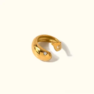 18K gold serpent ring top-down flat lay view showing elegant open C-wrap design with polished finish and cubic zirconia accent stone