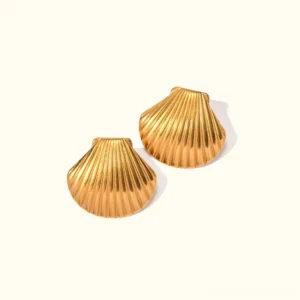18K gold shell stud earrings flat lay product photography with ribbed design and polished finish on off-white background