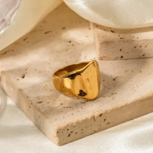 18K gold chunky signet ring three-quarter side view travertine stone high-shine angular curved top