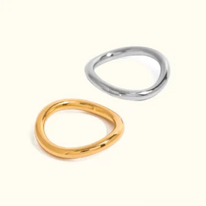 18K gold and silver dual-tone layered rings set - polished wavy design flat lay view on plain background