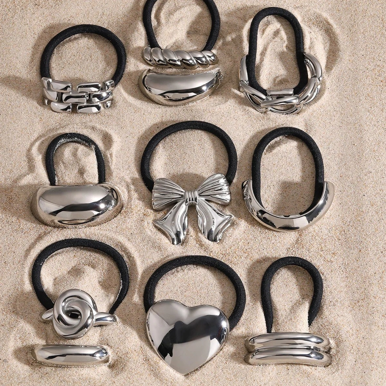 Collection of rose knot hair cuffs in gold and silver finishes flat lay display