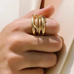 Two-tone 18K gold and silver stacked ring worn on hand close-up side view middle finger casual styling