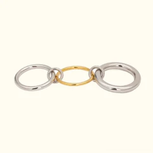 Two-tone 18K gold and silver stacked rings front view - flat lay on plain background showcasing linked polished metal bands