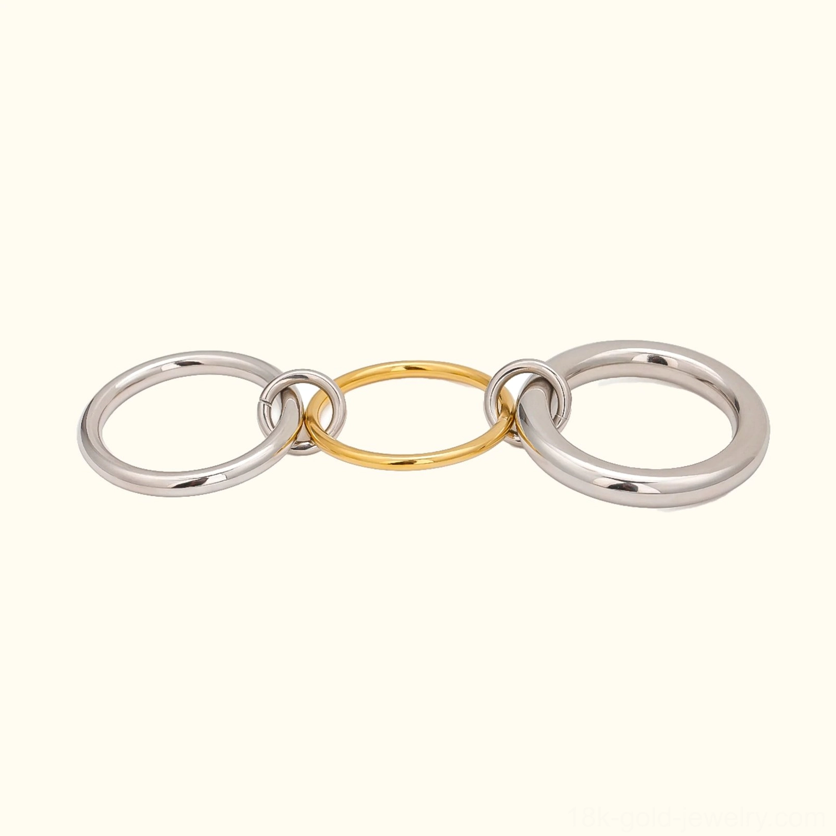 Two-tone 18K gold and silver stacked rings front view - flat lay on plain background showcasing linked polished metal bands