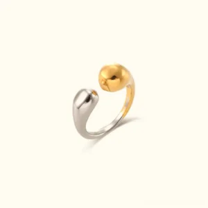 Two-tone 18K gold open teardrop adjustable ring with silver and gold polished finish on plain beige background front view