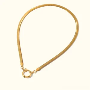 18K gold snake chain necklace with round pendant flat lay on white background showing herringbone chain design and spring clasp