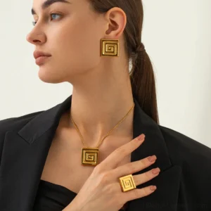 woman wearing 18K gold spiral jewelry set earrings necklace ring matching design