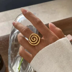 18K gold spiral ring worn on hand close-up middle finger bold metallic design lifestyle