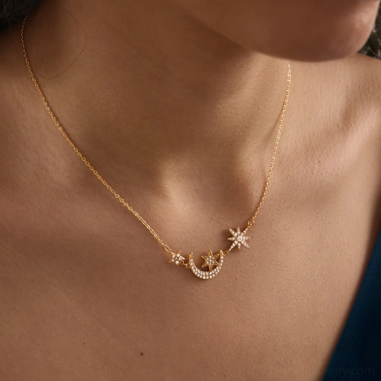 18K gold star moon pendant necklace single strand front close-up shot showing pavé diamond simulant detailing on model chest