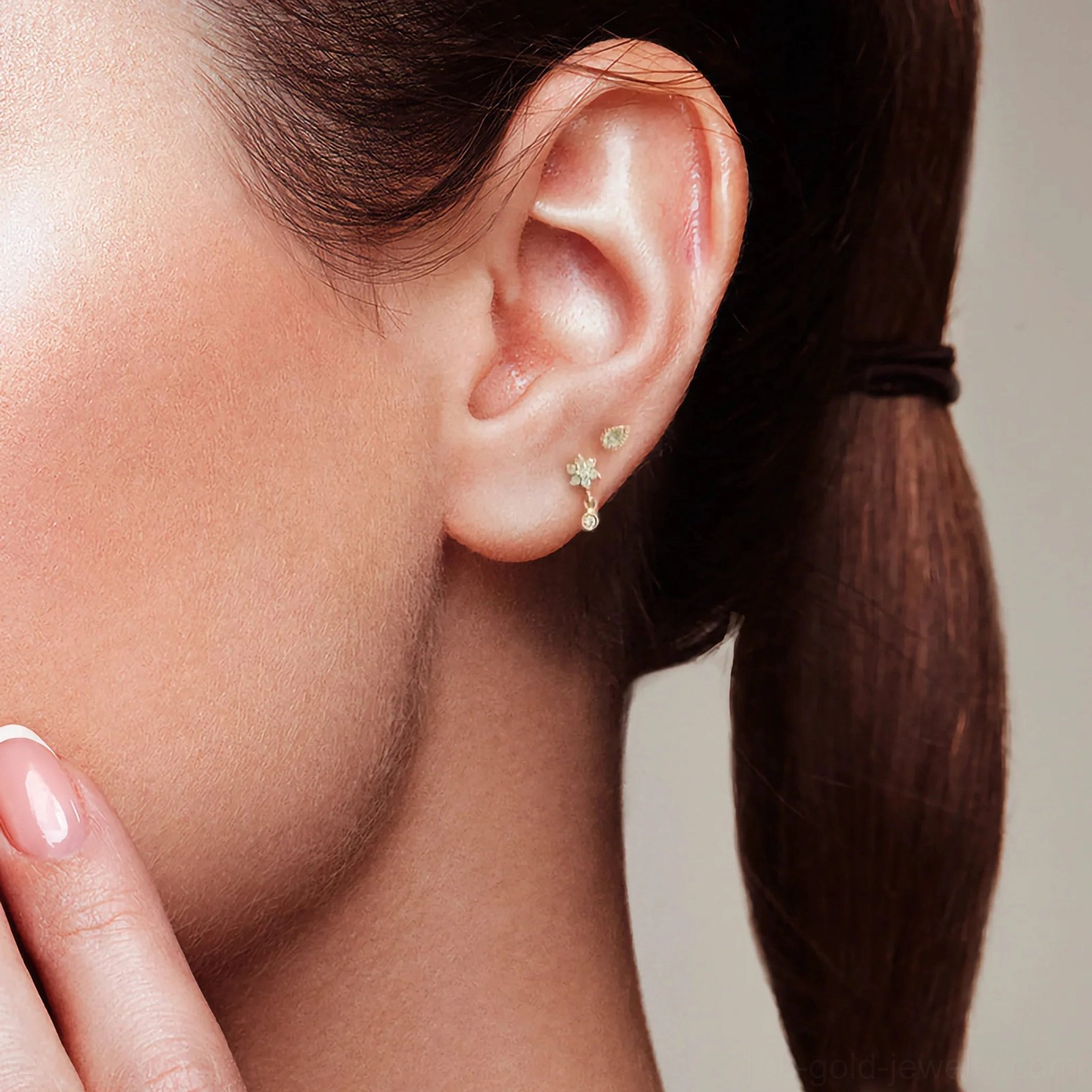 Tiny star drop stud earring 18K gold close-up side ear view model with low ponytail star-shaped cubic zirconia