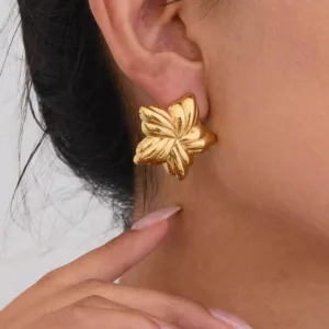 18K gold star stud earrings close-up side ear profile on model showing chunky smooth polished gold twisted star