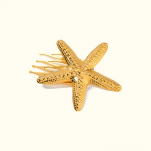 18K gold starfish hair comb front view flat lay with textured design and metal prongs on neutral background