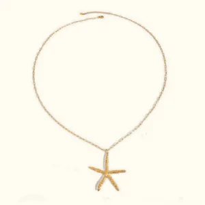 18K gold starfish necklace with textured pendant on delicate cable chain, flat lay product photography