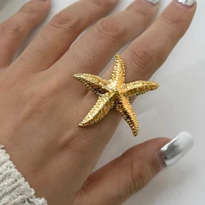 18K gold starfish ring on hand model wearing silver nails close-up wearable view