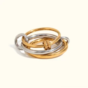 18K gold and sterling silver two-tone stackable rings with intertwined bands and knotted detail on plain white background, showing polished metallic finish and dual-tone composition