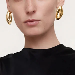 18K gold stud earrings worn on model close-up portrait chunky curved design front view