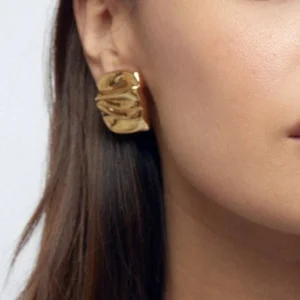 18K gold geometric studs worn on model, close-up ear view demonstrating how folded gold earrings look when styled and worn daily