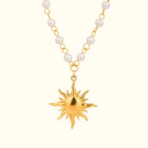 18K gold sun pearl necklace flat lay - delicate freshwater pearl pendant with sunburst charm on plain beige background front view