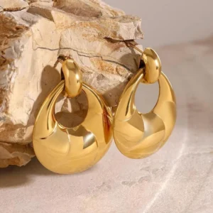 18K gold teardrop earrings close-up side view showing high-gloss finish and twisted texture detail