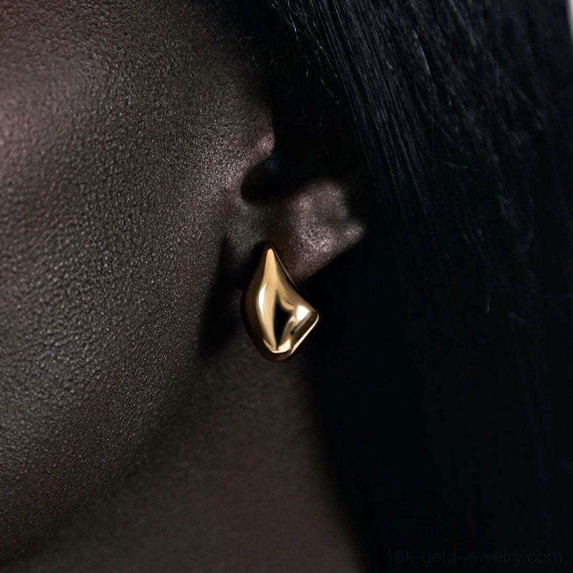 18K gold teardrop earrings on model minimalist stud earlobe detail elegant