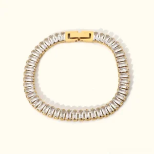 18K gold tennis bracelet with baguette cubic zirconia diamonds flat lay overhead view white background