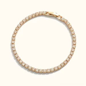 18K gold tennis bracelet with pavé cubic zirconia stones, top-down flat lay view showcasing full sparkle and design