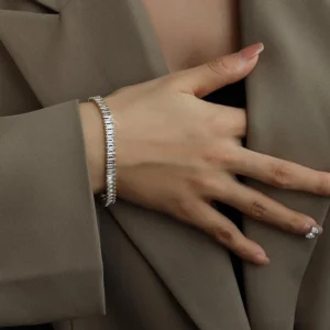 18K gold tennis bracelet worn on female wrist close-up side view professional styling