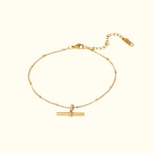 18k gold toggle anklet flat lay top view showing delicate beaded chain with bar toggle charm and adjustable extender