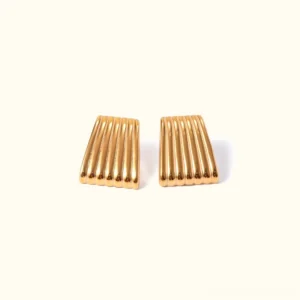 18K gold trapezoid stud earrings with vertical ribbed striped texture, front flat lay view on light beige background
