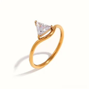 Trillion-cut diamond solitaire gold ring front three-quarter view studio shot, showcasing polished bezel-set stone and smooth 18K gold band