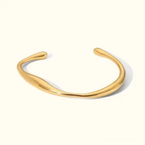 18K gold twisted open cuff bangle flat lay - polished gold finish minimalist bracelet design
