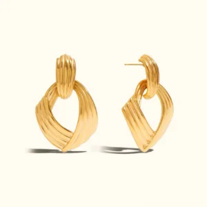 18K gold twisted knot drop earrings front flat lay product display ribbed textured surface