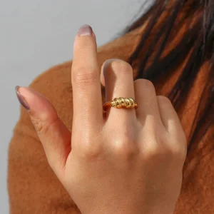 18K gold twisted knot ring worn on female finger hand wearing jewelry elegant gold band on woman hand