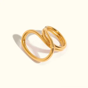 18K gold twisted open ring side view studio close-up with polished glossy finish and intertwined double circular bands on neutral background