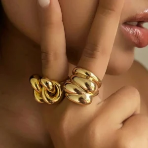 18K gold wrap ring worn on hand, chunky statement design with glossy finish, close-up detail shot