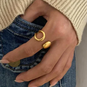 18K gold open ring on hand wearing beige sweater minimalist jewelry styling